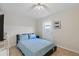 Bright bedroom with a ceiling fan, door to the outside, blue bedding and tile floors at 4219 Summerdale Dr, Tampa, FL 33624