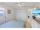 Bright bedroom featuring closet, door to outside, and TV area with wet bar and granite countertop at 4219 Summerdale Dr, Tampa, FL 33624