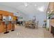 Open-concept dining area with tile floors, foosball table, and view of fireplace and bar at 4219 Summerdale Dr, Tampa, FL 33624
