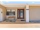 Inviting front entrance with a decorative glass door, bench seating, and well-maintained landscaping at 4219 Summerdale Dr, Tampa, FL 33624