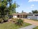 Landscaped front yard and a two-car garage complementing this inviting single-story home at 4219 Summerdale Dr, Tampa, FL 33624