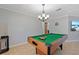 Game room showcasing a pool table with a chandelier, perfect for Gathering fun and entertainment at 4219 Summerdale Dr, Tampa, FL 33624