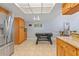 Kitchen area with stainless steel refrigerator, granite countertops, and adjacent foosball table at 4219 Summerdale Dr, Tampa, FL 33624