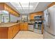 Well-lit kitchen with granite countertops, stainless steel appliances, and custom wood cabinets at 4219 Summerdale Dr, Tampa, FL 33624