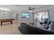 Relaxing living area with leather sofa, large TV, and sliding door access to the lanai at 4219 Summerdale Dr, Tampa, FL 33624