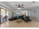 Spacious living room with dark leather furniture, large mirror, and access to an outdoor lanai at 4219 Summerdale Dr, Tampa, FL 33624