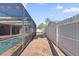 Covered patio with pool and brick walkway, leading to a fenced-in yard at 4219 Summerdale Dr, Tampa, FL 33624