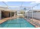 Inviting backyard swimming pool featuring a screened enclosure and a covered patio area at 4219 Summerdale Dr, Tampa, FL 33624