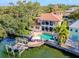 Aerial view of waterfront home featuring a pool, dock and lift at 44 Martinique Ave, Tampa, FL 33606