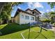 Lush backyard with artificial grass, a soccer net, and outdoor seating area at 44 Martinique Ave, Tampa, FL 33606