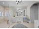 Bright bathroom featuring double vanities, large mirror, and glass enclosed shower at 44 Martinique Ave, Tampa, FL 33606