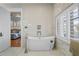 Modern bathroom featuring a soaking tub with backyard views and updated fixtures at 44 Martinique Ave, Tampa, FL 33606