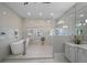 Bright bathroom featuring a soaking tub, glass shower, and marble countertops at 44 Martinique Ave, Tampa, FL 33606