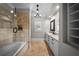 Light and bright bathroom featuring a shower over the tub and dual sink vanity with ample storage at 44 Martinique Ave, Tampa, FL 33606