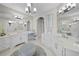 Spacious bathroom with dual vanities, makeup area, and decorative ottoman at 44 Martinique Ave, Tampa, FL 33606