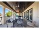 A well-designed covered patio with a ceiling fan and outdoor seating, ideal for enjoying waterfront views at 44 Martinique Ave, Tampa, FL 33606