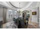 Dining room with tray ceilings, arched windows, stylish chandelier, and elegant decor at 44 Martinique Ave, Tampa, FL 33606