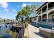 Exterior side view of a waterfront home with a dock, pool, and expansive outdoor living spaces at 44 Martinique Ave, Tampa, FL 33606