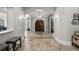 Spacious foyer with travertine floors, columns, arched entries, and statement front doors at 44 Martinique Ave, Tampa, FL 33606