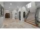 Foyer featuring tile floors, staircase, front doors, and ample lighting at 44 Martinique Ave, Tampa, FL 33606