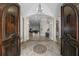 Grand foyer with arched entryway, decorative tile flooring, columns, and an elegant chandelier at 44 Martinique Ave, Tampa, FL 33606