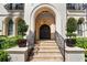Elegant front entrance features a grand arched doorway, stone steps, and meticulously manicured potted plants at 44 Martinique Ave, Tampa, FL 33606
