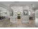 Open kitchen featuring a large island, travertine floors, pendant lights, and white cabinetry at 44 Martinique Ave, Tampa, FL 33606