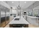 Bright open kitchen featuring a large island with seating, stainless steel appliances and modern fixtures at 44 Martinique Ave, Tampa, FL 33606
