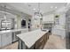 Bright, open kitchen featuring stainless steel appliances, large island and ample counter space at 44 Martinique Ave, Tampa, FL 33606