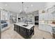 Spacious kitchen featuring a large island with seating, stainless steel appliances and an open floor plan at 44 Martinique Ave, Tampa, FL 33606