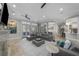 Bright living area with french doors, tile flooring, and a glimpse into the modern kitchen and dining area at 44 Martinique Ave, Tampa, FL 33606