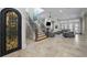 Bright living room featuring a staircase with iron railings, and travertine floors at 44 Martinique Ave, Tampa, FL 33606
