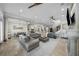 Expansive living room featuring tile floors, a ceiling fan, and a seamless view into the modern kitchen at 44 Martinique Ave, Tampa, FL 33606