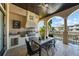 Well-equipped outdoor kitchen boasts built-in grill and hood, complimented by elegant travertine floors at 44 Martinique Ave, Tampa, FL 33606