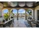 Spacious outdoor living area with travertine flooring, featuring views of the canal and neighboring properties at 44 Martinique Ave, Tampa, FL 33606