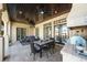 Inviting outdoor living area complete with a built-in grill, outdoor seating, and elegant travertine flooring at 44 Martinique Ave, Tampa, FL 33606