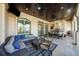 A relaxing outdoor living space complete with an outdoor kitchen, comfortable seating, and stylish travertine flooring at 44 Martinique Ave, Tampa, FL 33606