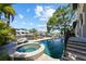 Stunning pool with spa, surrounded by lush greenery and waterfront views at 44 Martinique Ave, Tampa, FL 33606