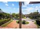 Street view of this home featuring circular driveway, lush landscaping, and mature trees at 44 Martinique Ave, Tampa, FL 33606