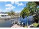 Waterfront home featuring a private dock with boat and jet ski lifts and beautiful waterfront views at 44 Martinique Ave, Tampa, FL 33606