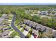 Aerial view of townhomes with lush landscaping showcases a well-maintained community with convenient parking at 440 Woods Landing Trl, Oldsmar, FL 34677