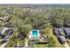 Aerial view of a community pool surrounded by greenery, offering a serene and private retreat at 440 Woods Landing Trl, Oldsmar, FL 34677