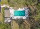 Aerial view of a sparkling community pool with ample seating, perfect for relaxation and recreation at 440 Woods Landing Trl, Oldsmar, FL 34677