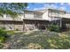 View of the backyard and back of home featuring screened-in patios and greenery at 440 Woods Landing Trl, Oldsmar, FL 34677