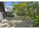 View of the spacious backyard including foliage, grass, trees, and more at 440 Woods Landing Trl, Oldsmar, FL 34677