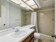 A bathroom featuring a shower stall with tile surround, a toilet and a large mirror above the vanity at 440 Woods Landing Trl, Oldsmar, FL 34677