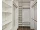 A spacious walk-in closet features multiple shelves and hanging rods, providing ample storage at 440 Woods Landing Trl, Oldsmar, FL 34677