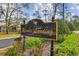 The 'Woods Landing' community sign boasts manicured landscaping, creating a welcoming entrance at 440 Woods Landing Trl, Oldsmar, FL 34677