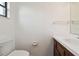 Clean half bathroom featuring a vanity with storage and a toilet at 440 Woods Landing Trl, Oldsmar, FL 34677