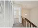 View of upstairs hallway featuring closet with white doors and wood railing at 440 Woods Landing Trl, Oldsmar, FL 34677